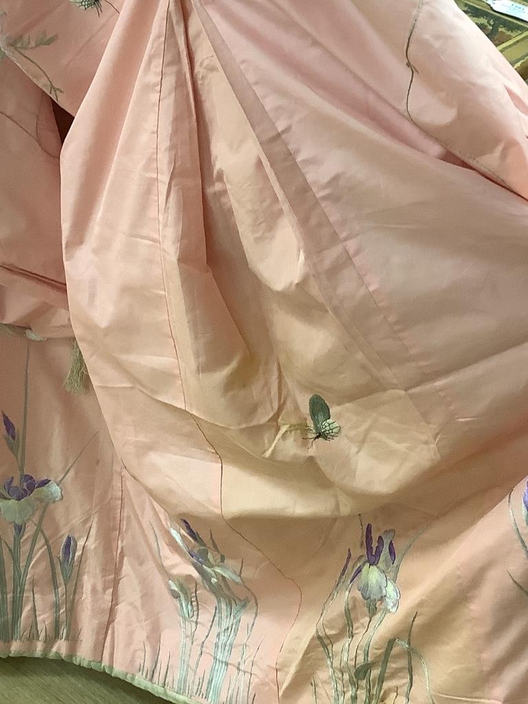 A pink silk Japanese kimono embroidered with wisteria and irises and butterflies, length 140cm, together with a red kimono embroidered with white wisteria and carnations